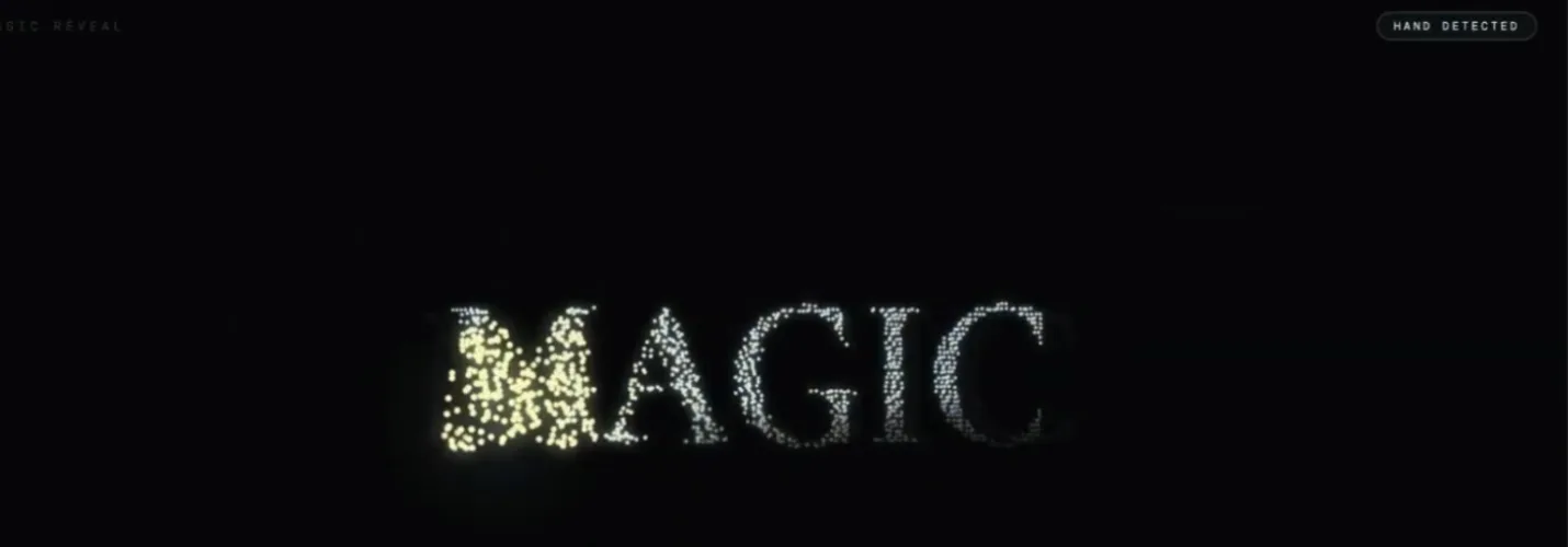 A particle-dust rendering of the word "MAGIC" with a "hand detected" badge, driven by webcam hand-tracking